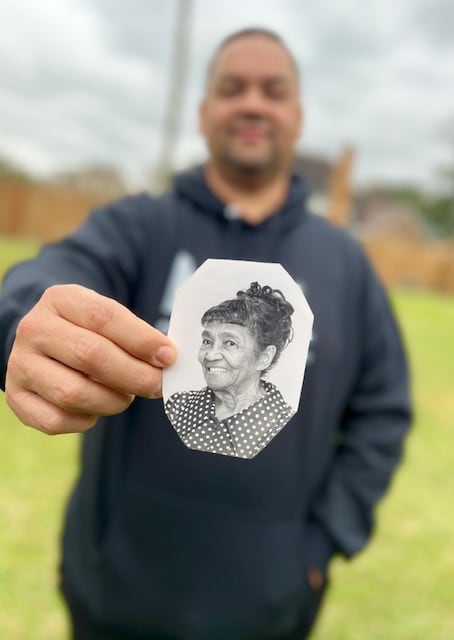 Todd holding a photo of his grandma Avia